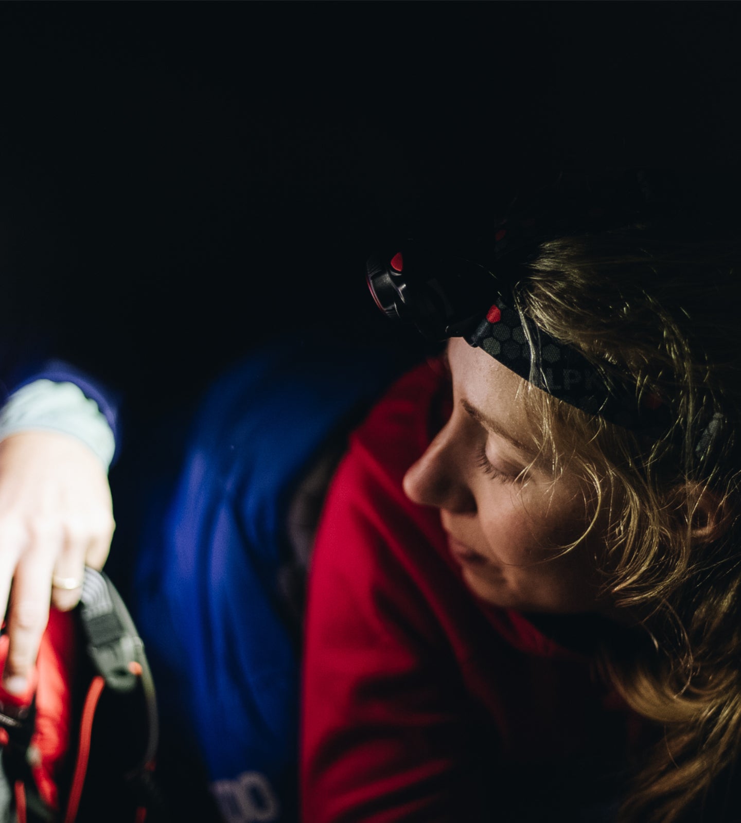 2 campers on an expedition wearing head torches