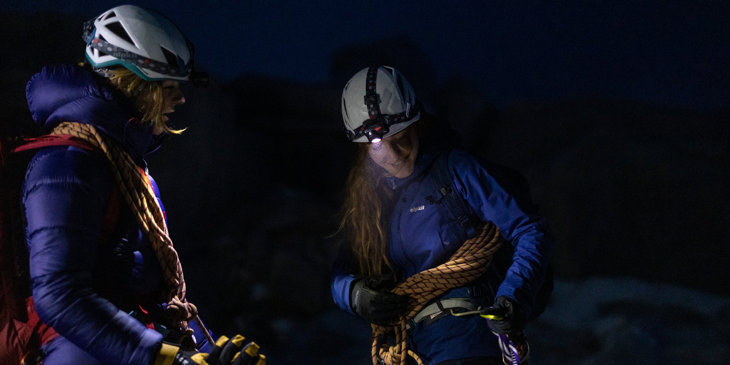 Two night time climbers wearing headtorches