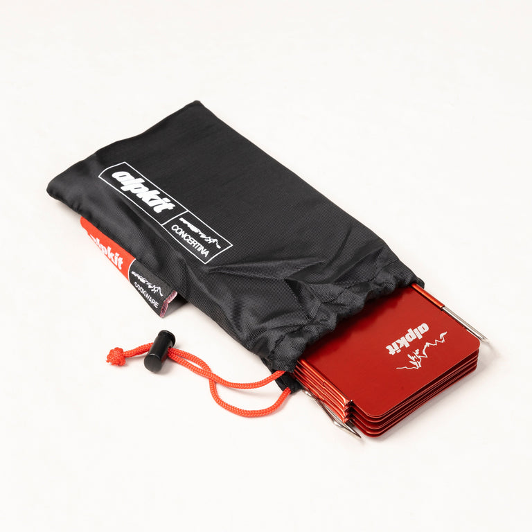 alpkit concertina windshield for camping stoves folded in red