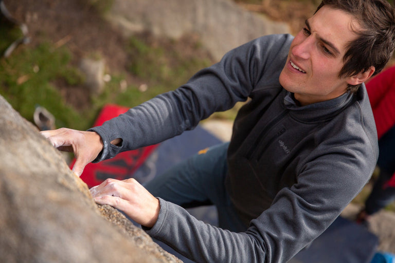 A man bouldering in a stretch fleece top - action|sl