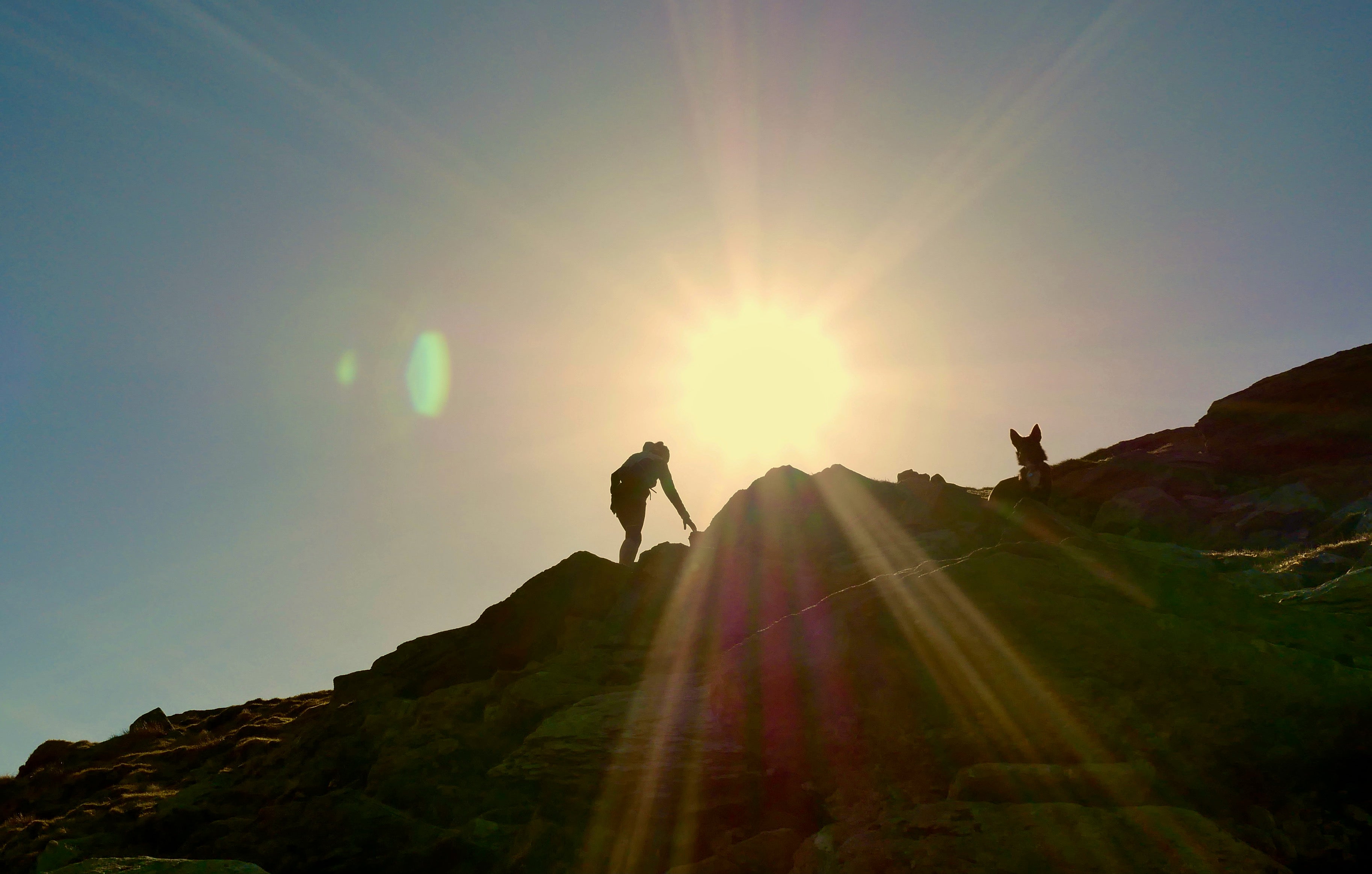 Walking up steep mountain side with the sun setting