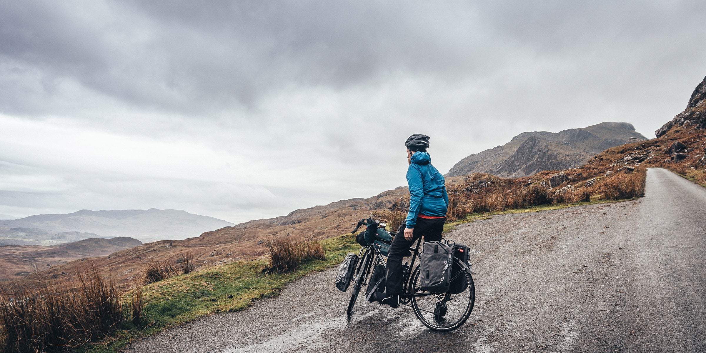Man on touring bike on a quiet road in North Wales
