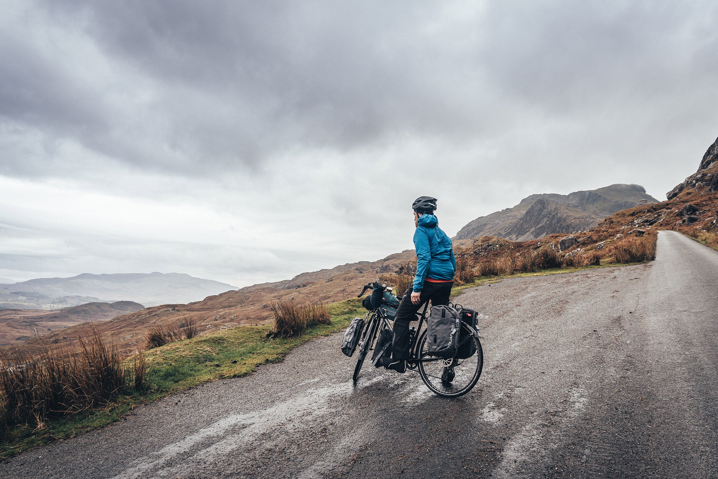Man on touring bike on a quiet road in North Wales