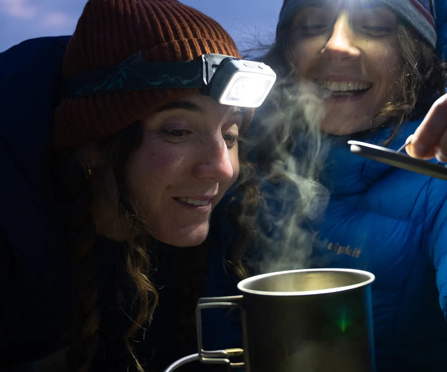 Campers cooking with headtorches