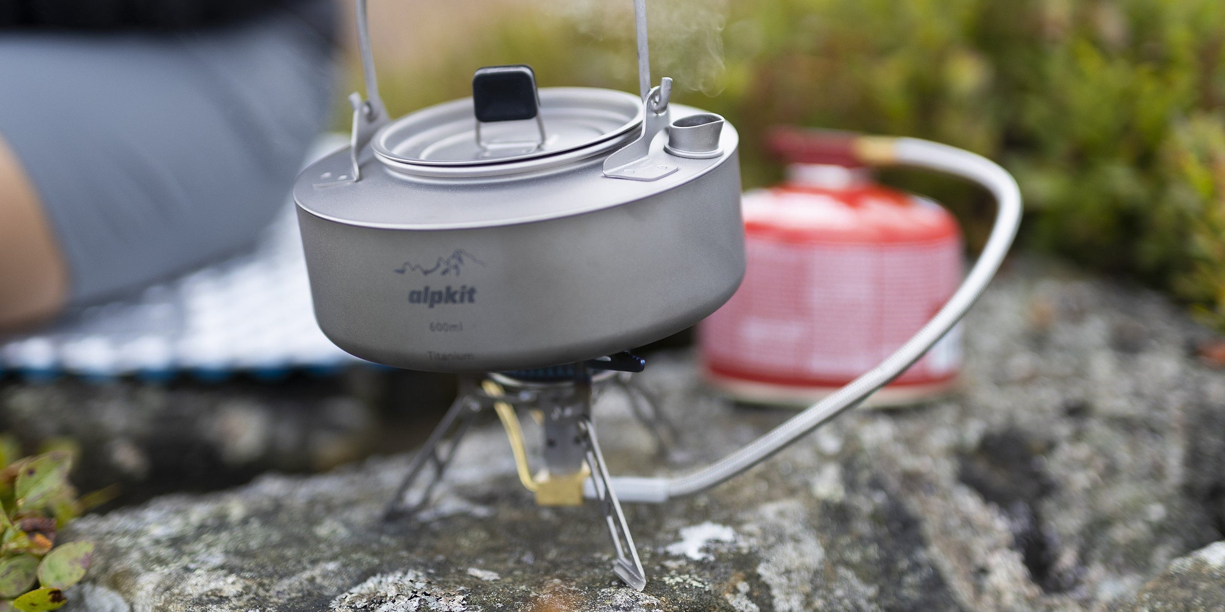 Camping gas canister attached to a camping stove