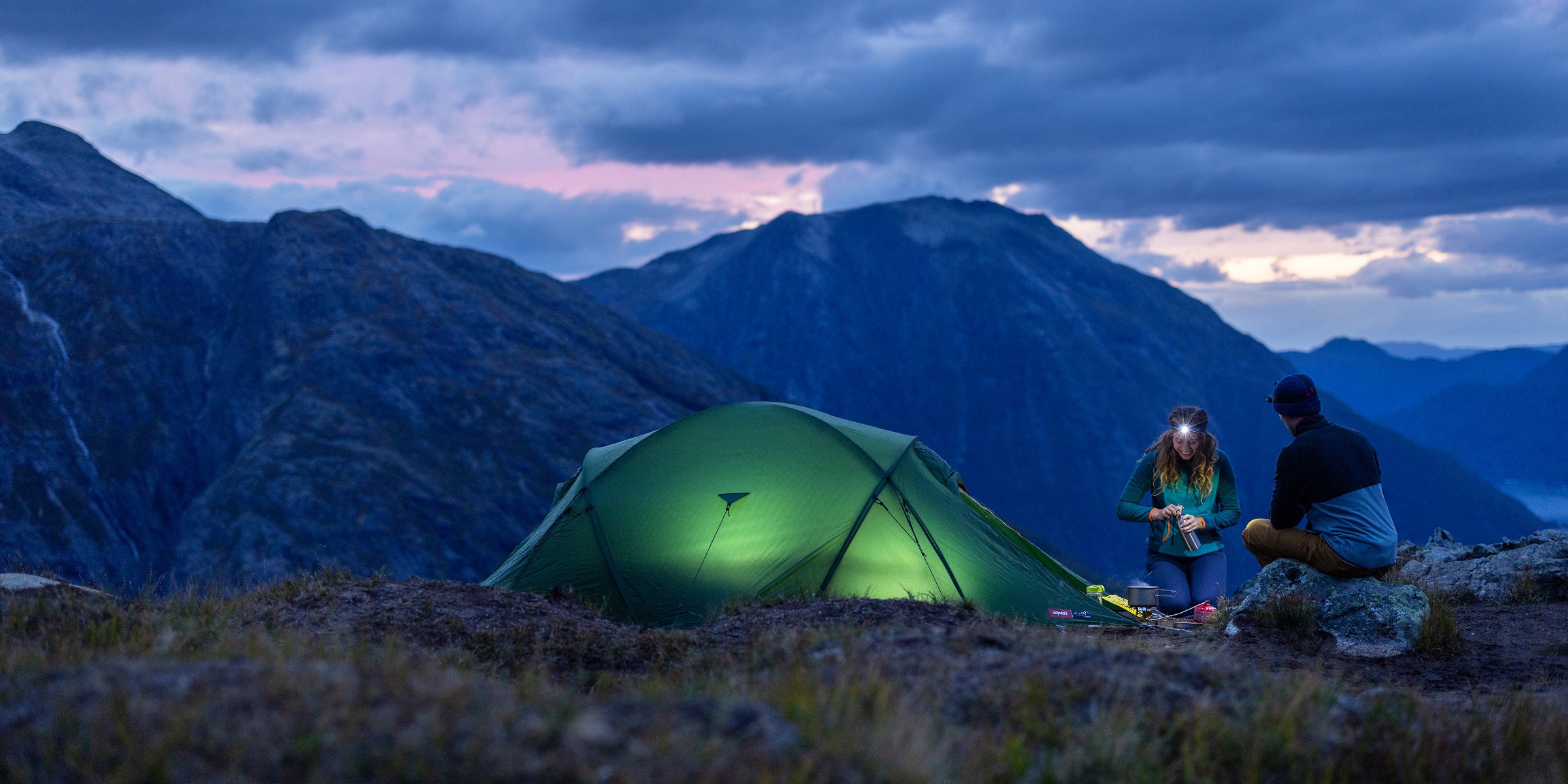 Wild camping with tent lit up in the night