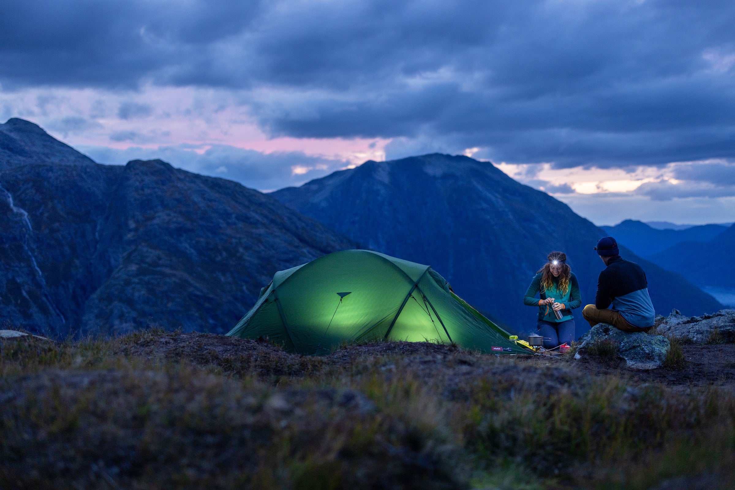 Wild camping with tent lit up in the night