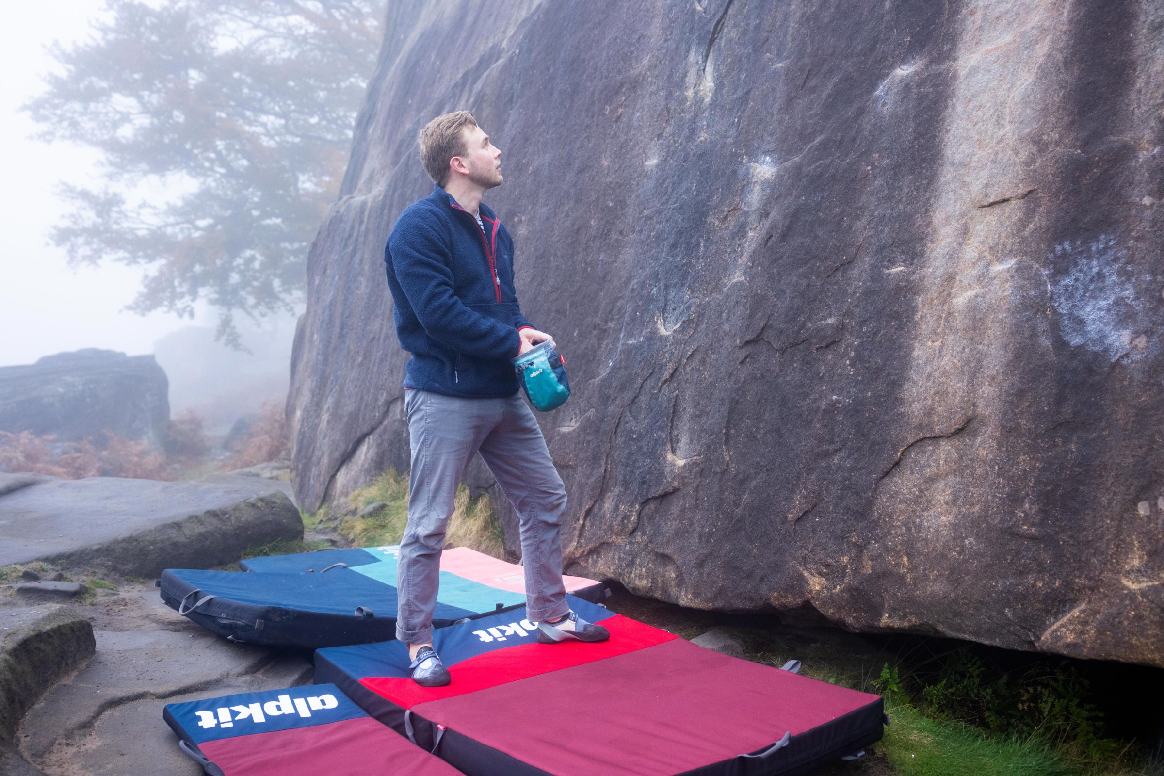Bouldering above crash pads in the Peak District