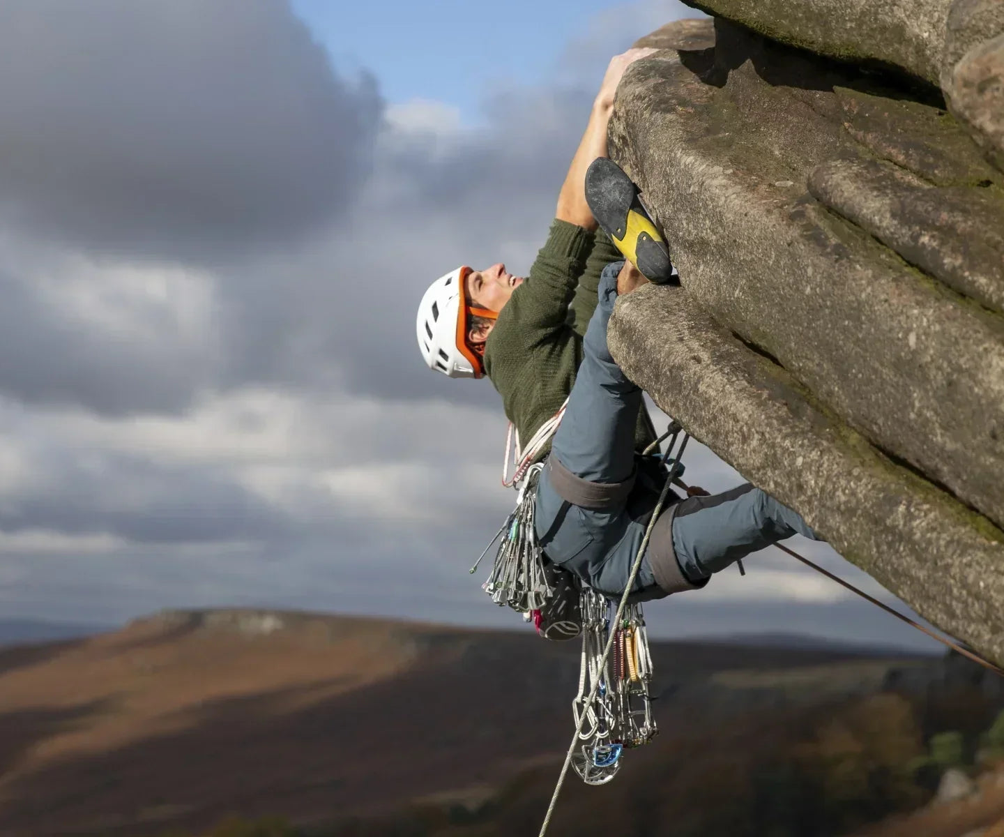 Climber on the Flying Butress overhang on Stanage