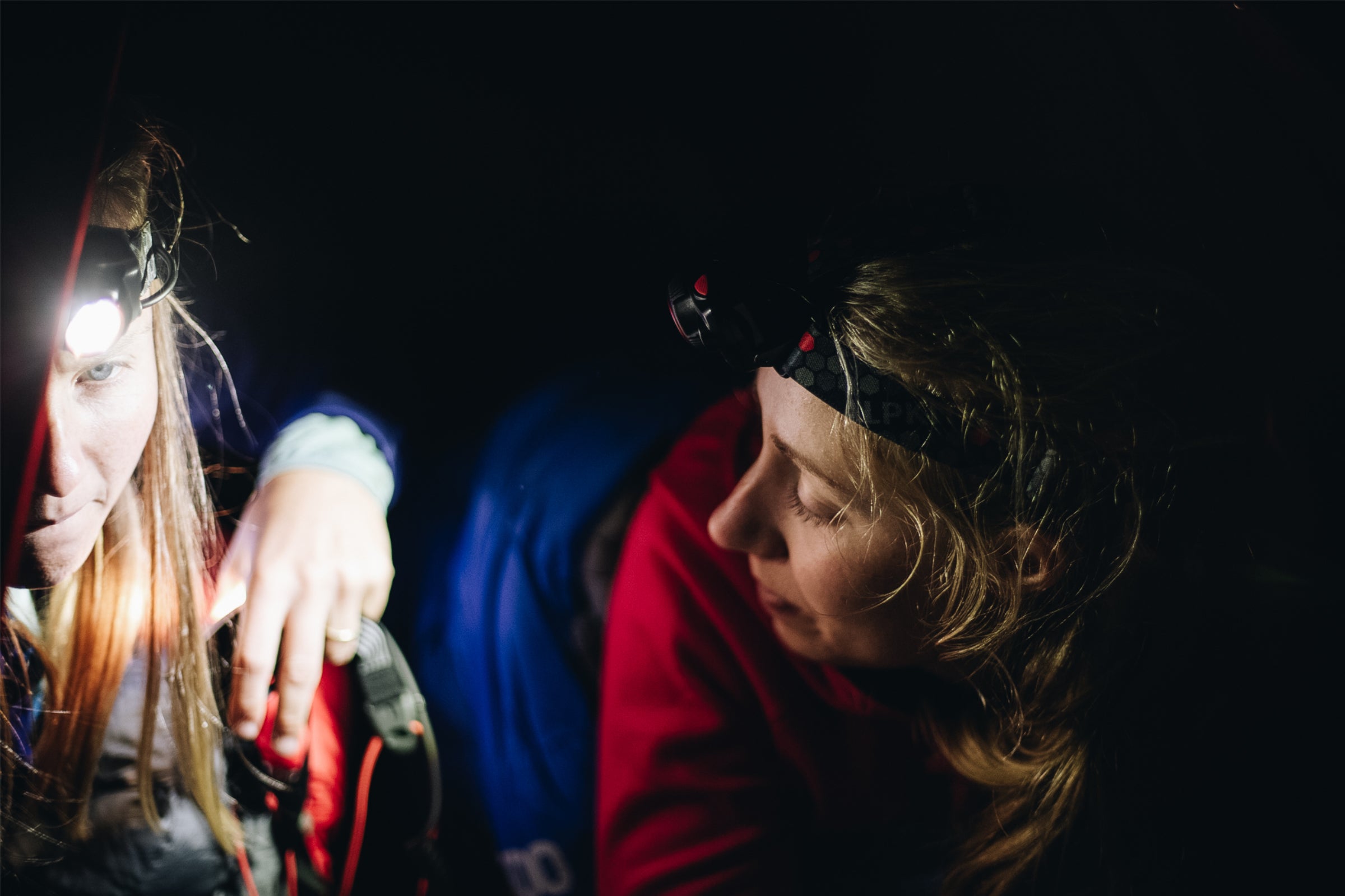 2 campers on an expedition wearing head torches