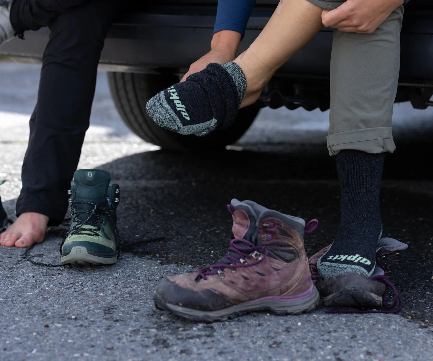 Hikers pulling on walking boots