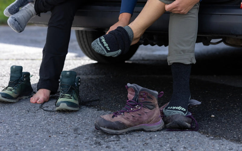 Hikers pulling on walking boots