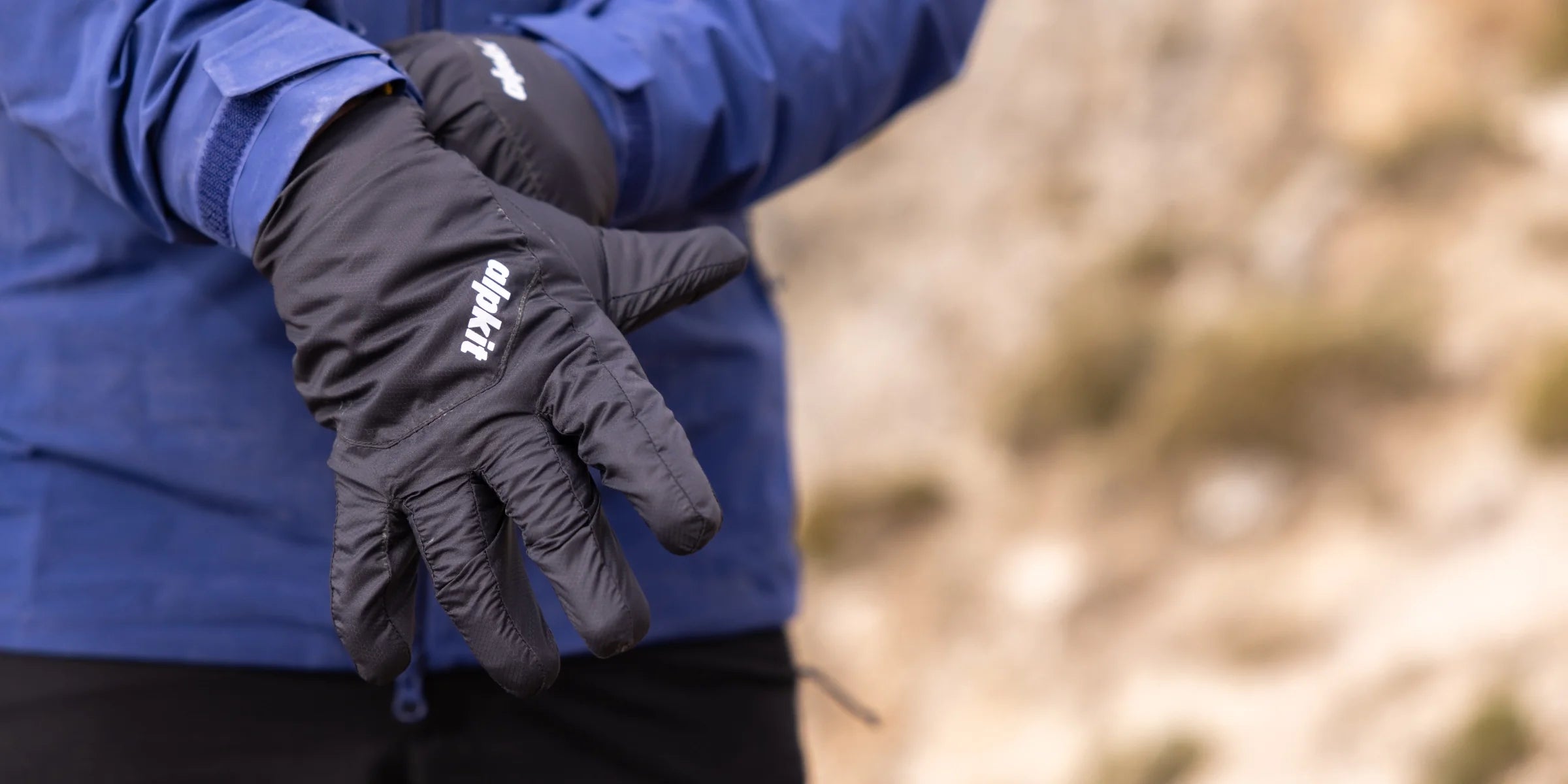 Hillwalker pulls on insulated gloves