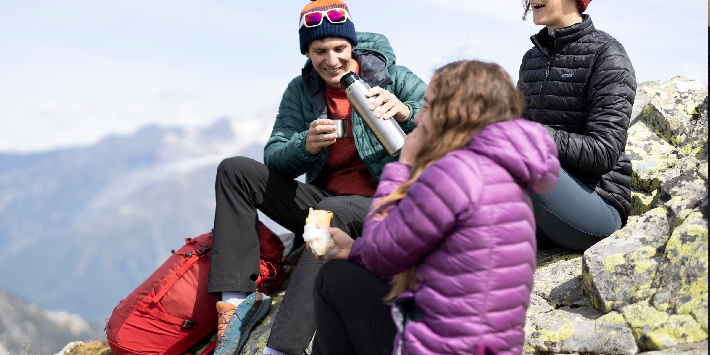 Popping on a down jacket during a break hillwalking
