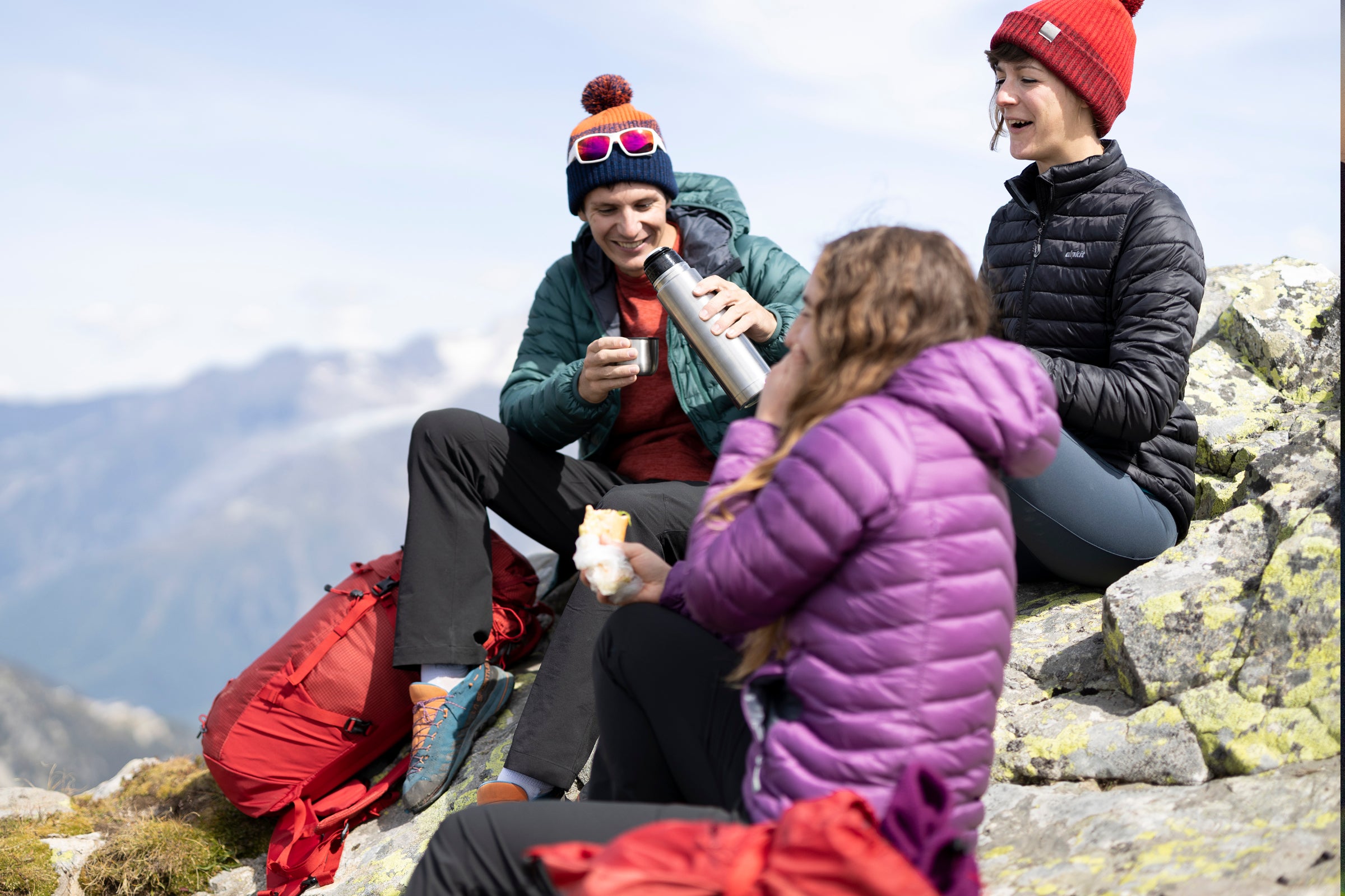 Popping on a down jacket during a break hillwalking