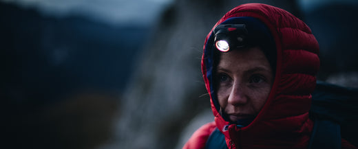 Using a lightweight LED head torch to read a map at night
