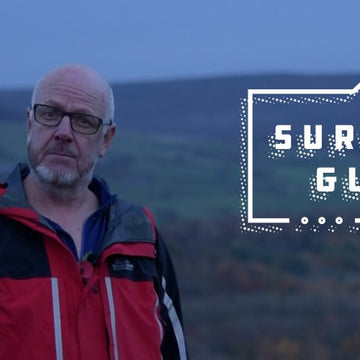 Campers sit outside a tent illuminated by LED torches