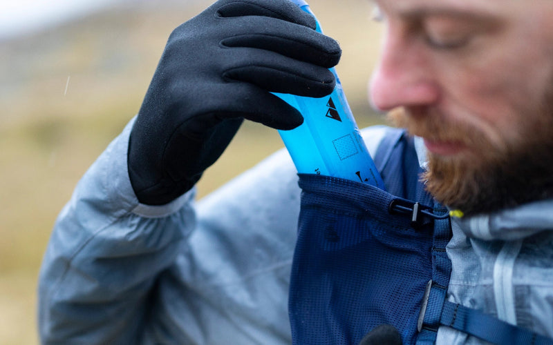 Trail runner rehydrating