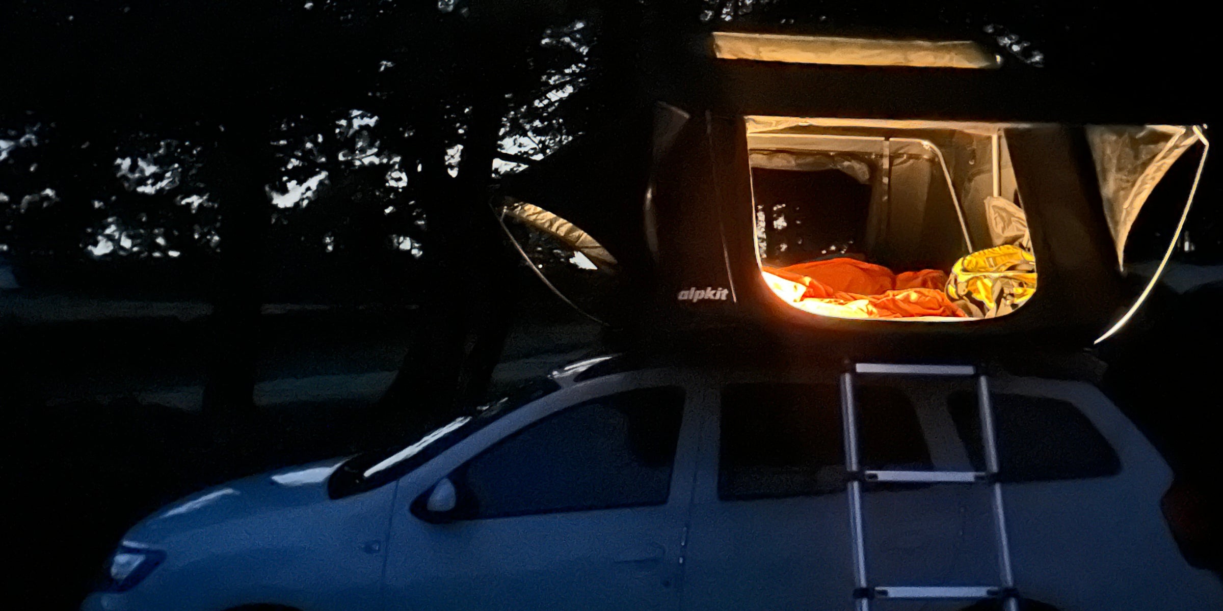 Roof tent lit by lamplight