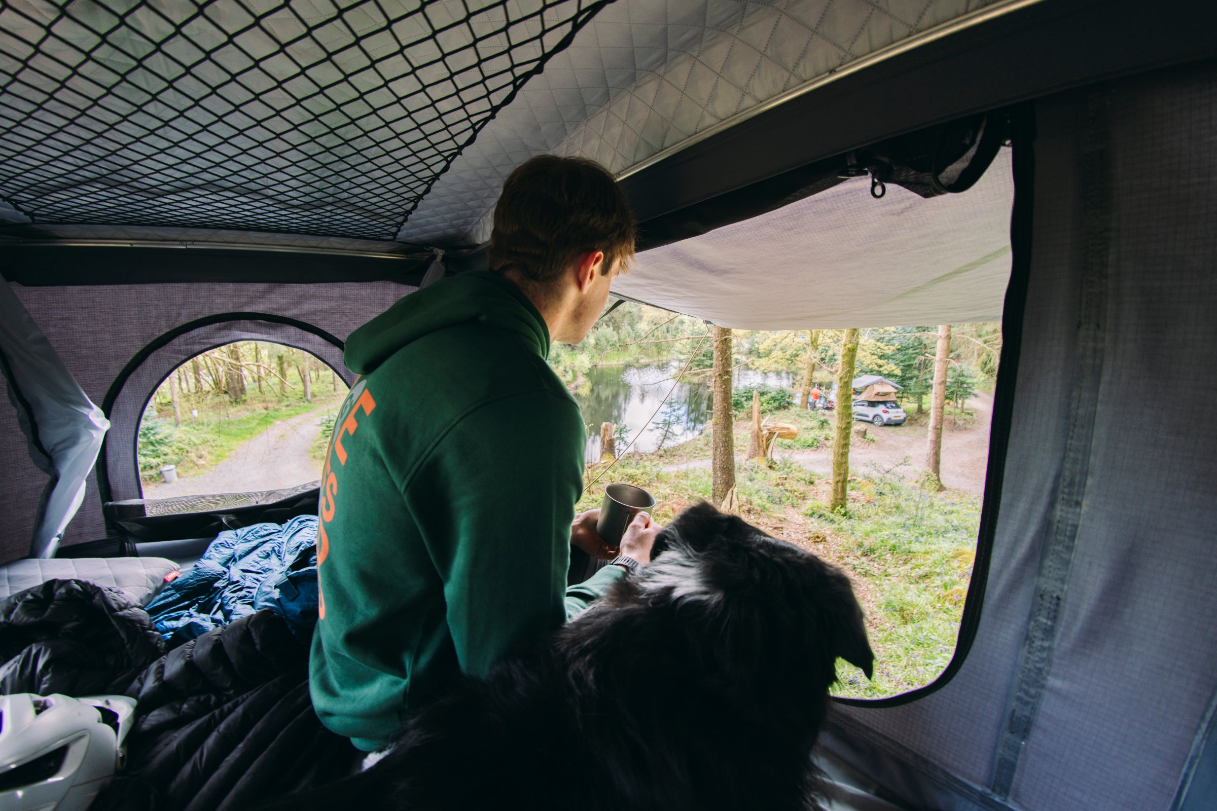 Camper and dog in roof tent