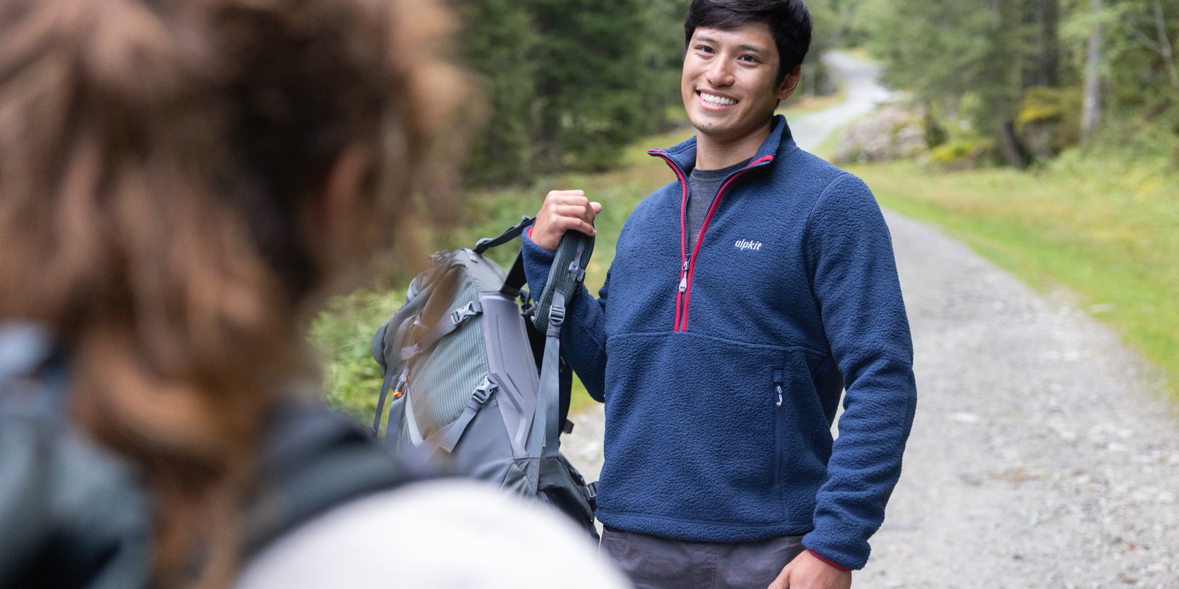 Hiker wearing a fleece pullover on the trail