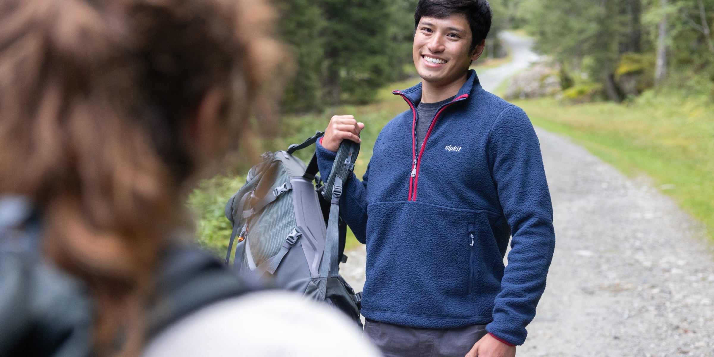 Hiker wearing a fleece pullover on the trail
