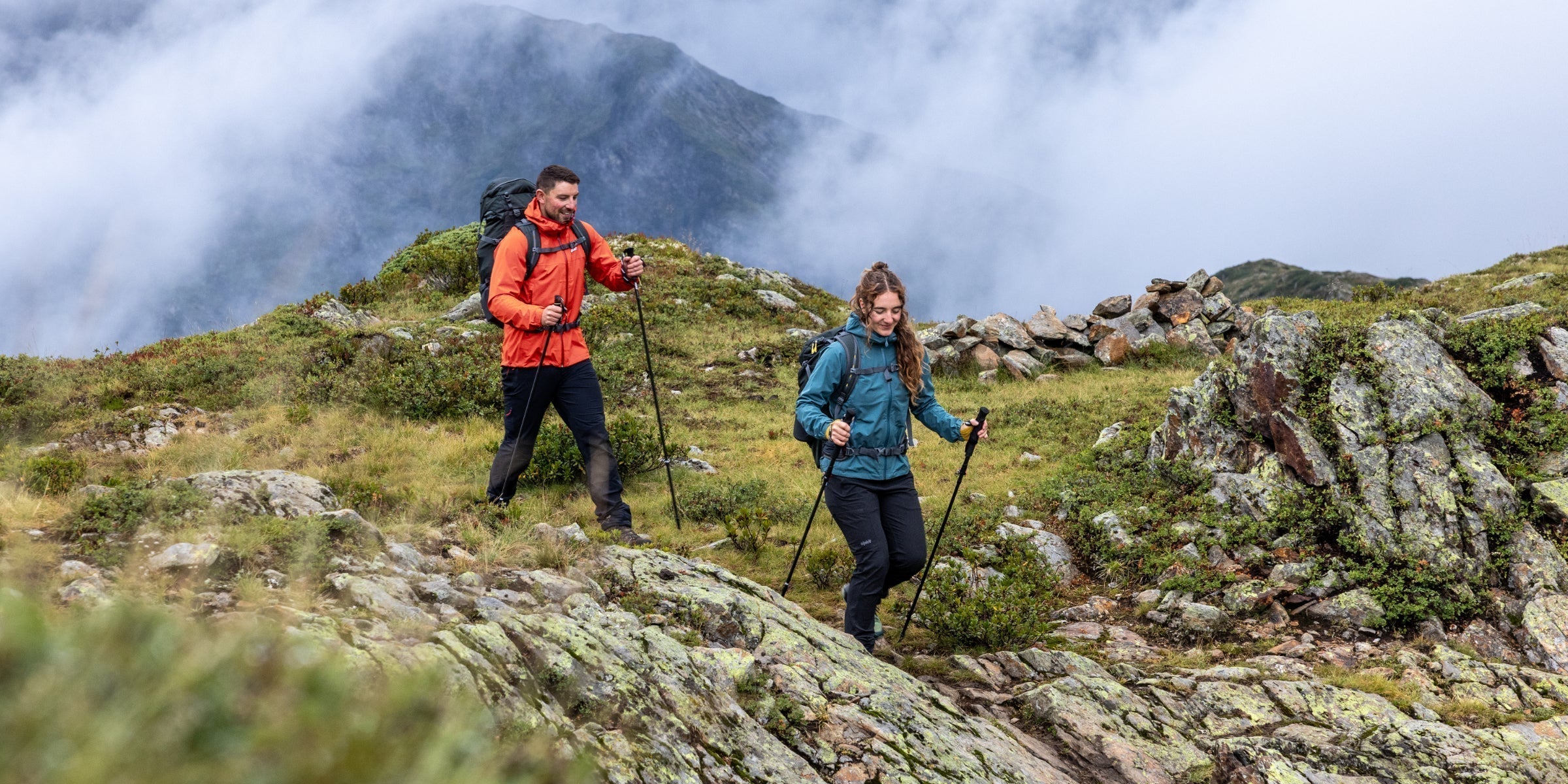 Hikers on a mountain trail dressed in waterproofs