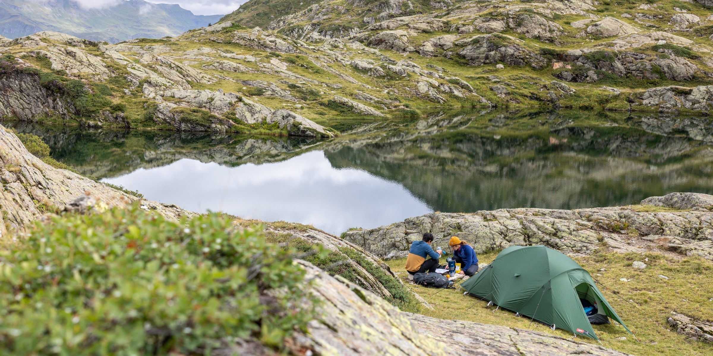 Wild camping by a lake in the mountains