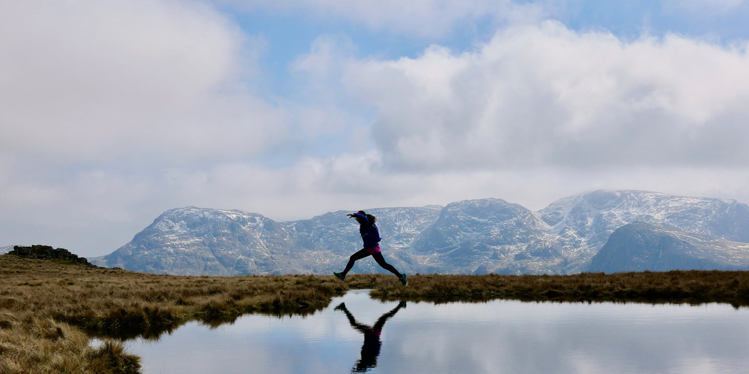 Female trail runner in the winter mountains