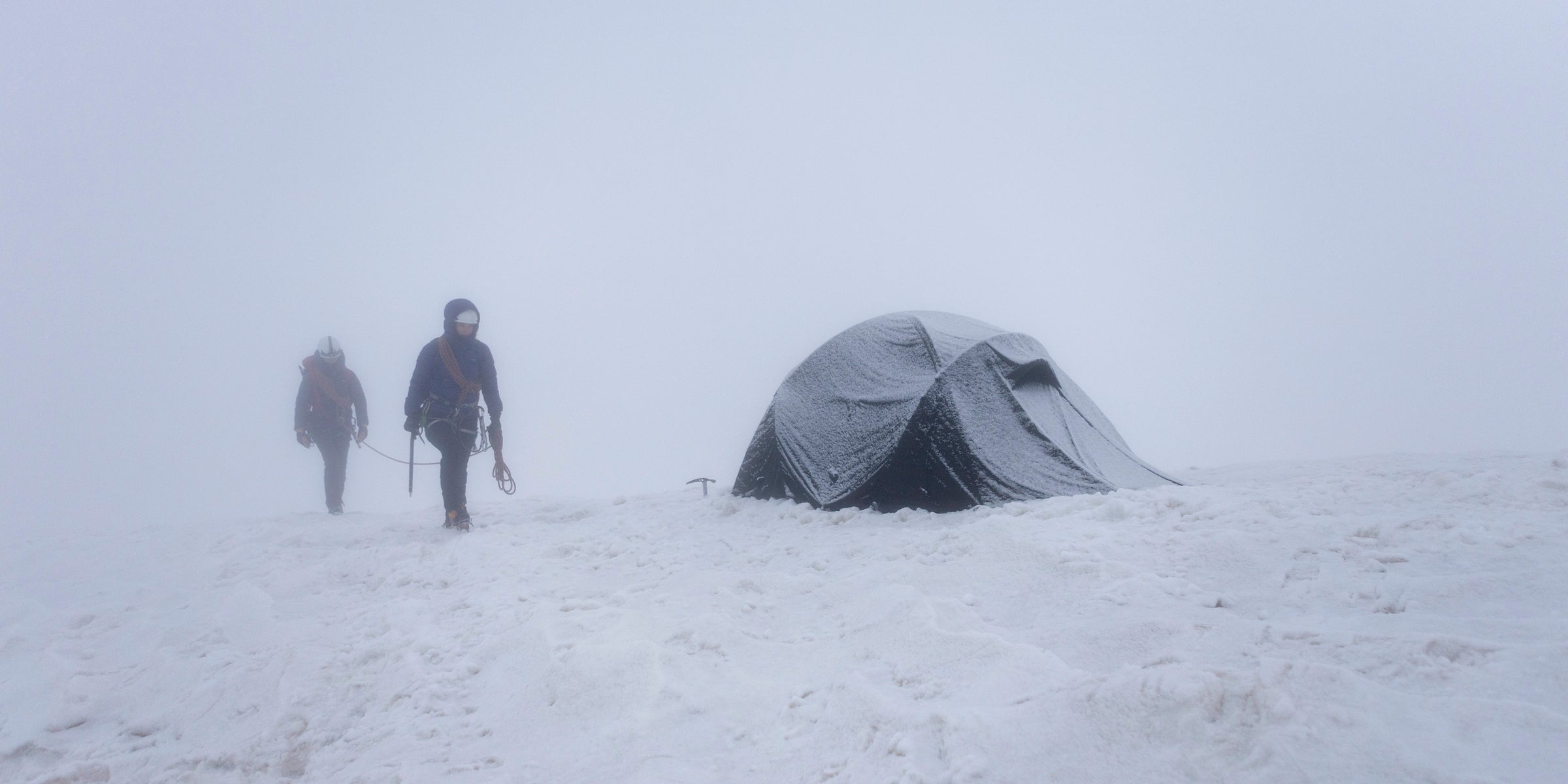 A winter geodesic tent in a whiteout