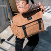 a man walking down stairs with a whisky bairn pro messenger bag