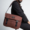 a man sitting on a stool with the bairn pro messenger in port colour