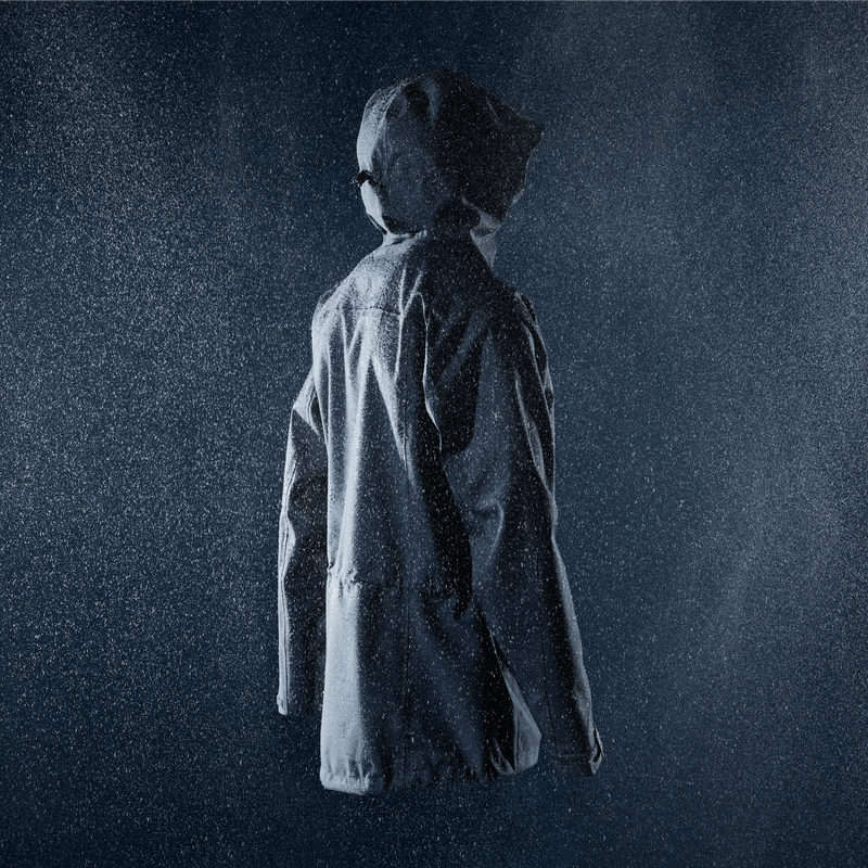 Shot of the Alpkit Fortitude Waterproof Jacket in a rainy studio