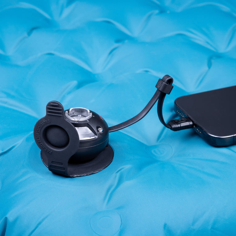 Micro Turbine Camping Mat Pump close up in use, powered by a mobile phone