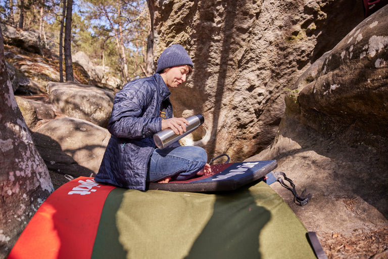 Zofia Reych sat on the Phud bouldering pad in Font - action