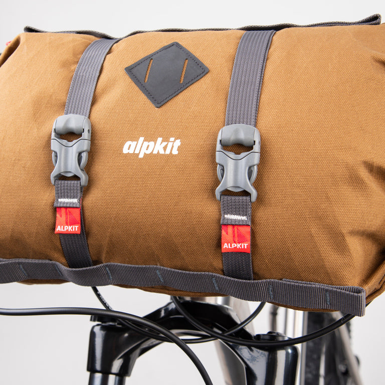 alpkit kuoka handlebar bag for bike packing in mountain brown strap