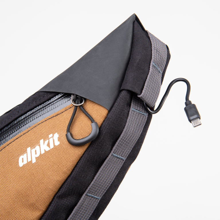 alpkit possum frame bag for bikepacking in mountain brown cable port